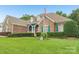Attractive brick home with manicured landscaping, an American flag, and charming green shutters at 1575 Williamsburg Dr, Rock Hill, SC 29732