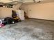 Garage with concrete flooring, a lawn mower, and storage shelving at 1575 Williamsburg Dr, Rock Hill, SC 29732