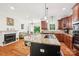 Beautiful open kitchen with granite countertops, wooden cabinets, and an adjoining seating area with fireplace at 1575 Williamsburg Dr, Rock Hill, SC 29732