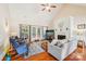 Bright living room with a fireplace, hardwood floors, and French doors to the backyard at 1575 Williamsburg Dr, Rock Hill, SC 29732