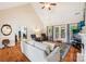 Bright living room featuring hardwood floors, fireplace, ceiling fan and French doors to the deck at 1575 Williamsburg Dr, Rock Hill, SC 29732