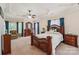 Expansive main bedroom featuring a tray ceiling, ceiling fan, sitting area, and ensuite bathroom at 1575 Williamsburg Dr, Rock Hill, SC 29732