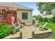 Charming patio with brick pavers, Adirondack chairs and low brick wall is perfect for entertaining or relaxing outdoors at 1575 Williamsburg Dr, Rock Hill, SC 29732