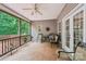 Enjoy relaxing times on this covered patio featuring a ceiling fan, comfortable furniture, and wooded views at 1575 Williamsburg Dr, Rock Hill, SC 29732