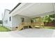 Back porch with wooden stairs, exposed beams and fan at 1721 S New Hope Rd, Gastonia, NC 28054