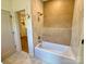 Bathroom featuring decorative tile, modern fixtures, relaxing bathtub, and an adjacent walk in closet at 1721 S New Hope Rd, Gastonia, NC 28054