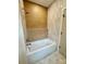 Modern bathroom features a stylish bathtub with unique decorative tile surround and sleek fixtures at 1721 S New Hope Rd, Gastonia, NC 28054