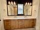 Bathroom featuring double vanity with wooden cabinets, modern fixtures, and tile accents at 1721 S New Hope Rd, Gastonia, NC 28054