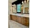Stylish bathroom boasts double vanity with marble countertop, undermount sinks, and modern lighting fixtures at 1721 S New Hope Rd, Gastonia, NC 28054