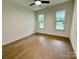 Bright bedroom with hardwood floors, two windows, and ample natural light at 1721 S New Hope Rd, Gastonia, NC 28054