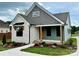 Charming home featuring stone accents, gray siding, inviting porch, and professionally landscaped front yard at 1721 S New Hope Rd, Gastonia, NC 28054