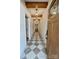 Welcoming home entryway featuring decorative tile floor, wood door, beams, and modern light fixtures at 1721 S New Hope Rd, Gastonia, NC 28054