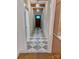 Hallway with decorative tile floors leading to a wooden front door and decorative pendant lights at 1721 S New Hope Rd, Gastonia, NC 28054