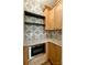 Charming kitchen with stylish tile backsplash, built-in microwave, granite counters, and custom cabinets at 1721 S New Hope Rd, Gastonia, NC 28054