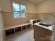 Laundry room with built-in bench, storage, stylish tile and sink at 1721 S New Hope Rd, Gastonia, NC 28054
