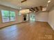 Bright living room featuring hardwood floors, stone fireplace, and access to the outdoor deck at 1721 S New Hope Rd, Gastonia, NC 28054