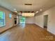 Spacious open-concept living room with fireplace, hardwood floors, modern lighting, and a view of outdoor patio at 1721 S New Hope Rd, Gastonia, NC 28054