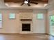 Living room boasting stone fireplace and wooden mantle, as well as access to outdoor deck at 1721 S New Hope Rd, Gastonia, NC 28054