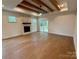 Spacious living room with beautiful hardwood floors, stone fireplace, and beamed ceiling at 1721 S New Hope Rd, Gastonia, NC 28054