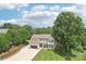 Aerial showcasing the home's roof, manicured lawn, mature trees, and surrounding landscape at 207 Spaniel Se Dr, Concord, NC 28025