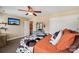 Cozy bedroom boasts a comfortable bed, fan, TV, double closets and soothing wall color at 207 Spaniel Se Dr, Concord, NC 28025