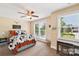 Sunlit bedroom with neutral walls, comfortable bed, and ample natural light from two windows at 207 Spaniel Se Dr, Concord, NC 28025