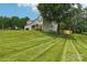 Exterior showcasing a well-maintained lawn, attached garage, and classic architecture at 207 Spaniel Se Dr, Concord, NC 28025
