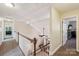 Upstairs hallway with natural light, view of the living room, and bedroom access at 207 Spaniel Se Dr, Concord, NC 28025