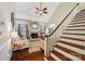 Bright living room with fireplace, hardwood floors, and staircase at 207 Spaniel Se Dr, Concord, NC 28025