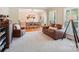 Open living room with comfortable leather seating and view into dining area at 207 Spaniel Se Dr, Concord, NC 28025