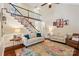 Open living room with staircase, plush seating, and natural light at 207 Spaniel Se Dr, Concord, NC 28025