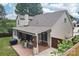 Covered patio featuring a lounge area and grill, perfect for outdoor entertainment at 207 Spaniel Se Dr, Concord, NC 28025
