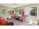 Bright sunroom with wicker furniture, large windows, and access to the outdoors at 207 Spaniel Se Dr, Concord, NC 28025