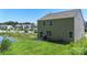 This backyard features a patio, grill, and view of the pond with new landscaping at 2527 Linhay Dr, Charlotte, NC 28216