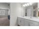 This bathroom offers double sinks, white cabinets and a large mirror at 2527 Linhay Dr, Charlotte, NC 28216