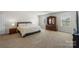 Bright bedroom features neutral carpeting, natural light, and traditional wood furnishings at 2527 Linhay Dr, Charlotte, NC 28216