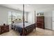 Bedroom with four poster bed, dark wood furnishings and natural light at 2527 Linhay Dr, Charlotte, NC 28216