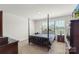 Bedroom with four poster bed, dark wood furnishings and natural light at 2527 Linhay Dr, Charlotte, NC 28216