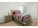 Comfortable bedroom with a queen-sized bed, matching nightstand, and natural light at 2527 Linhay Dr, Charlotte, NC 28216