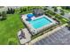 A view of the community pool, playground, and parking, with a blue umbrella and many chairs at 2527 Linhay Dr, Charlotte, NC 28216
