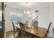 Well-lit dining room showcases a large wooden table with decorative chairs, alongside a view of the front door at 2527 Linhay Dr, Charlotte, NC 28216