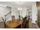 Spacious dining room with decorative chairs and wooden table, complemented by a staircase view at 2527 Linhay Dr, Charlotte, NC 28216