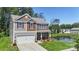 View of the attractive home near a tranquil pond, showing its blend of stone, siding, and landscaped lawn at 2527 Linhay Dr, Charlotte, NC 28216