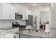 Modern kitchen featuring white cabinets, granite countertops, stainless steel appliances and open view to the dining room at 2527 Linhay Dr, Charlotte, NC 28216