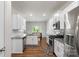 Bright kitchen boasts white cabinets, granite countertops, stainless steel appliances and hardwood flooring at 2527 Linhay Dr, Charlotte, NC 28216