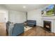 Spacious living room boasts a fireplace, mantle, and a view of the home's exterior on the television at 2527 Linhay Dr, Charlotte, NC 28216