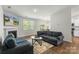 Living room showcases a fireplace, mantle, large window, and opens to the kitchen and dining area at 2527 Linhay Dr, Charlotte, NC 28216