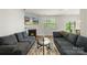 Bright living room features a fireplace, mantle, large window with a view of the backyard at 2527 Linhay Dr, Charlotte, NC 28216