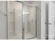 This shower features glass door, white tile and a showerhead at 2527 Linhay Dr, Charlotte, NC 28216