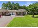 Inviting brick townhome featuring an attached garage, a cozy front porch, and a well-maintained lawn at 2541 26Th Ne Ave, Hickory, NC 28601